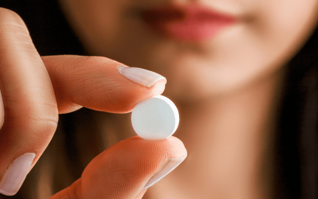 woman holding the abortion pill